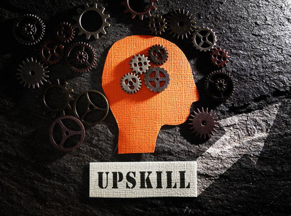Head and gears with Upskill text and arrow